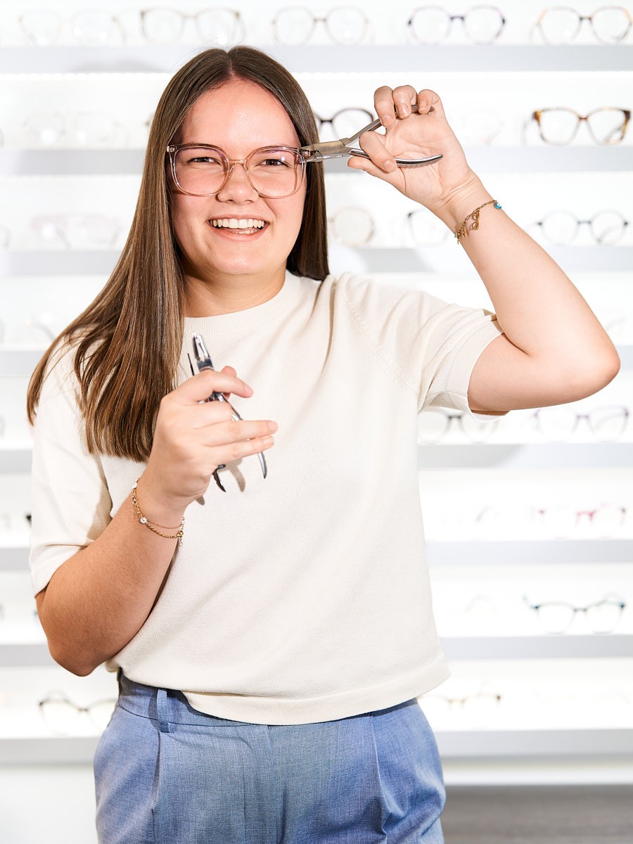 Optical team member with professional tools for the precise adjustment and fitting of modern eyewear.