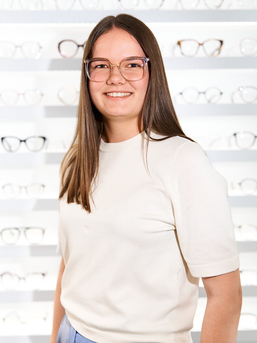 Optical team member wearing modern glasses with a focus on personal advice and finding the right eyewear.